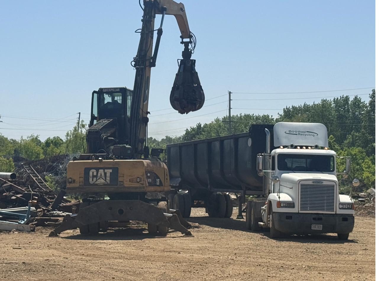 Material handler and hauling truck loading for recovery