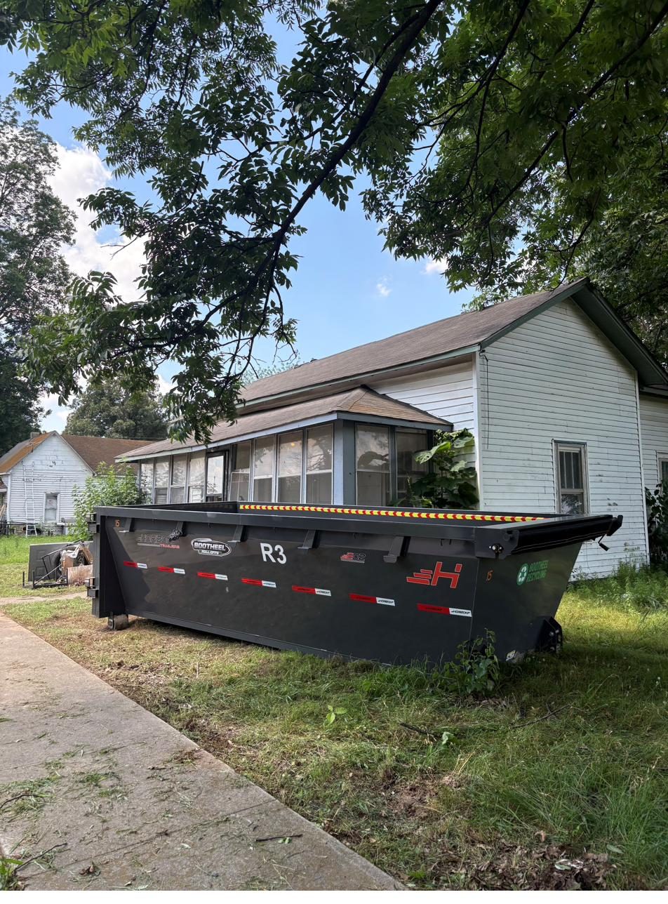 Roll-off container placed at a residential property for a cleanout